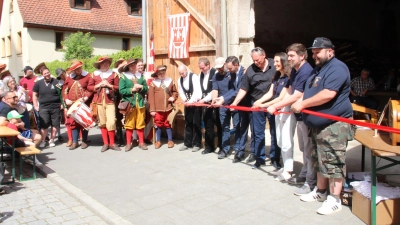 Die Festspiel-Verantwortlichen durchschnitten gemeinsam mit dem neuen Oberbürgermeister Christoph Rösch (Fünfter von rechts) und Handwerkern das rote Band. (Foto: Clarissa Kleinschrot)
