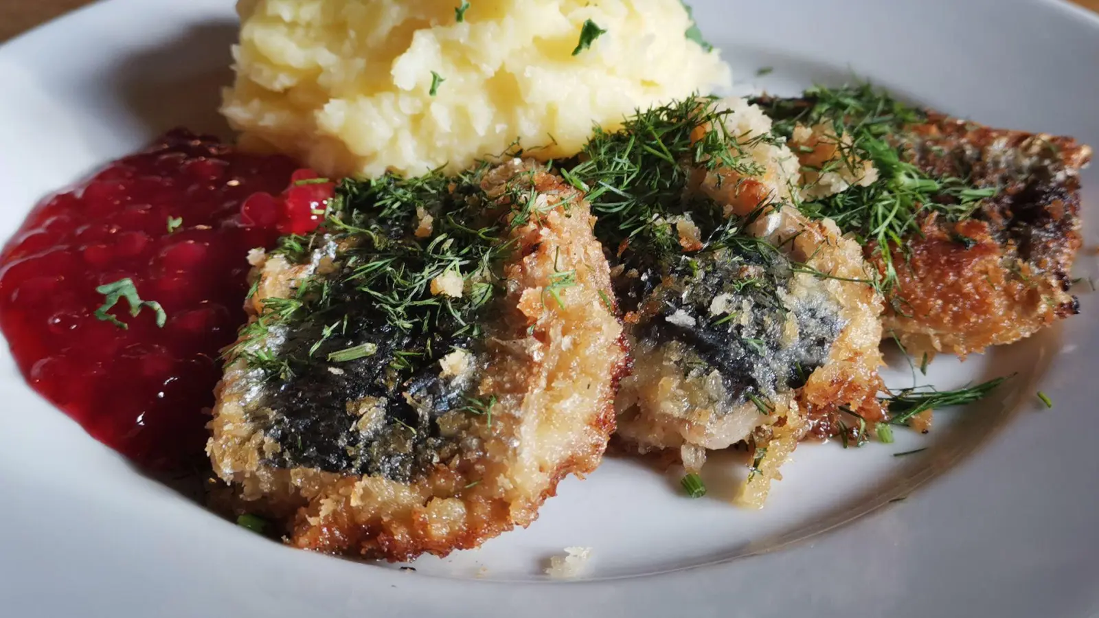 Bevor der Hering im Doppelpack mit Panko paniert und gebraten wird, kommt zwischen beide Filets ein Senf-Zwiebel-Mix als Füllung.   (Foto: Geraldine Friedrich/dpa-tmn)
