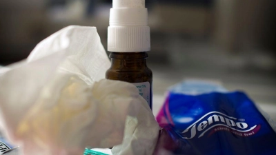 Mittel gegen Erkältung wie Nasenspray, Halstabletten und Papiertaschentücher liegen auf einem Tisch. (Foto: Arno Burgi/dpa-Zentralbild/dpa/Illustration)