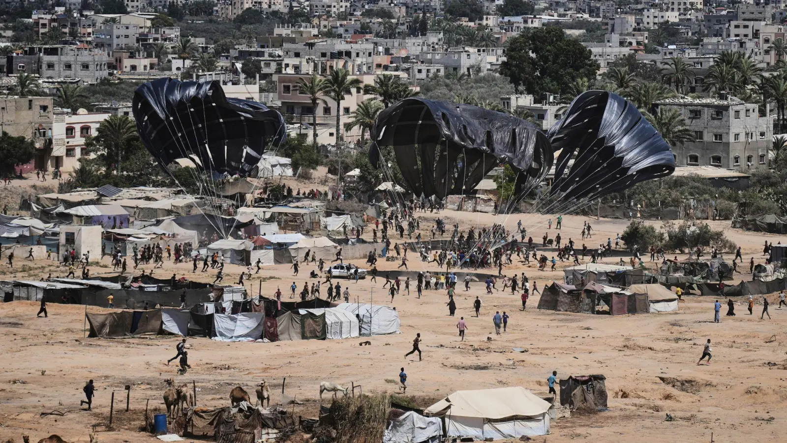 Hilfsgüterabwurf: Palästinenser sammeln Versorgungsgüter im Gazastreifen (Foto: Abdel Kareem Hana/AP/dpa)