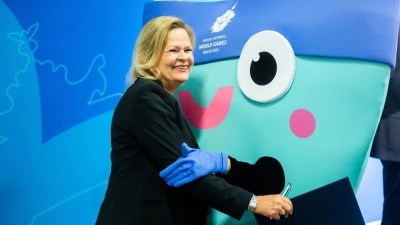 Bundesinnenminister Nancy Faeser umarmt das Maskottchen „Unity“ der Special Olympics World Games. (Foto: Christoph Soeder/dpa)