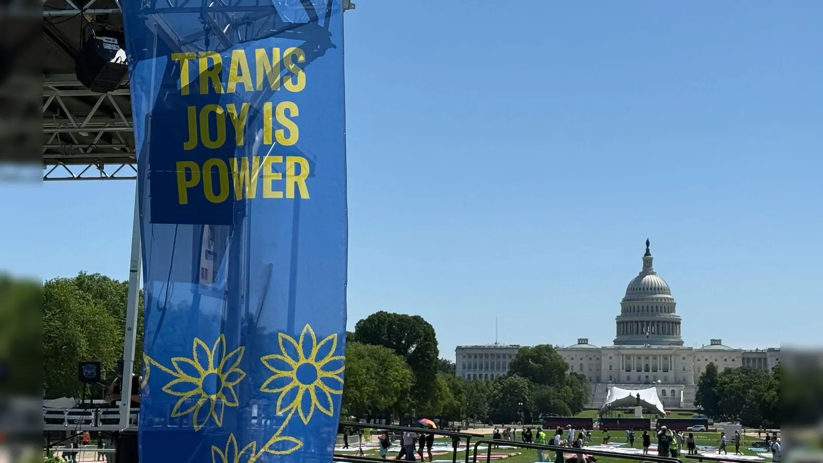 „Trans joy is power“ steht auf einem Banner an einer Bühne vor dem Kapitol am ersten Tag der Worldpride.  (Foto: Franziska Spiecker/dpa)