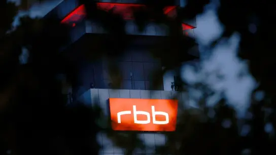 Das beleuchtete Logo des Senders Rundfunk Berlin-Brandenburg (RBB) ist an der Fassade am Sitz des Senders zu sehen. (Foto: Carsten Koall/dpa)