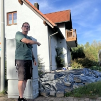 Claus Eichner vor dem Verteiler. Rechts dahinter unter der Plane will er den Carport errichten. (Foto: Karl-Heinz Panzer)