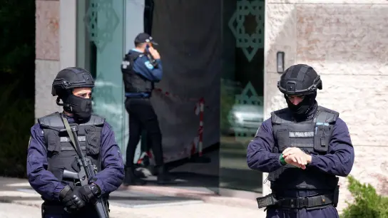 Polizeibeamte stehen am Eingang des Ismailitische Zentrum in Lissabon. (Foto: Armando Franca/AP/dpa)