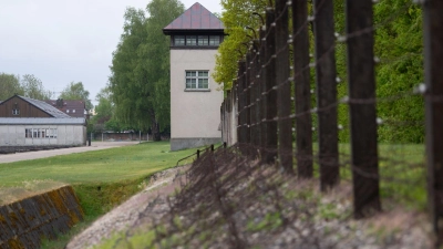 Ein Zaun und ein Wachturm sind an der Gedenkstätte des Konzentrationslagers Dachau zu sehen. (Foto: Sven Hoppe/dpa)