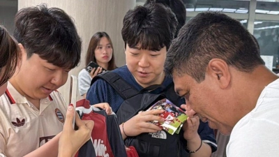 Der frühere Bayern-Profi Giovane Elber gibt Autogramme (vorne r) am Flughafen. (Foto: Christian Kunz/dpa)