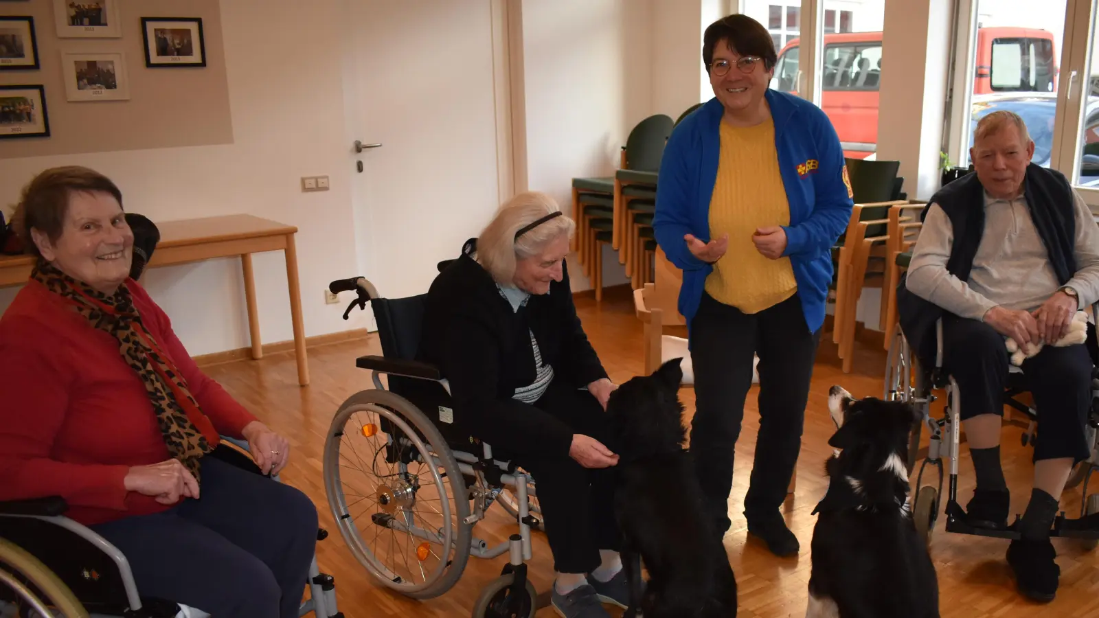 Moni Nunn (stehend) besucht regelmäßig mit ihren beiden Hunden die Hospitalstiftung, ein Alten- und Pflegeheim, in Bad Windsheim. Die Seniorinnen und Senioren freuen sich über den tierischen Besuch. Manch' einer hat einen plüschigen Vierbeiner mitgebracht. (Foto: Ute Niephaus)