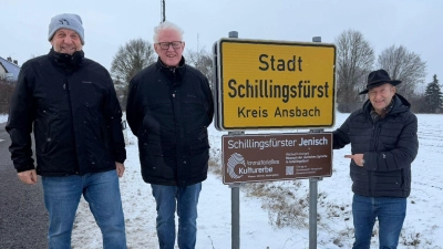 Auf die Jenisch-Sprachinsel Schillingsfürst weisen nun auch braune Hinweistafeln unter den gelben Ortsschildern hin. Das Foto zeigt die Macher des Jenisch-Museums, Markus Löschel und Johannes Munique, mit Bürgermeister Michael Trzybinski an der Stadtzufahrt Ansbacher Straße. (Foto: Thomas Trzybinski)