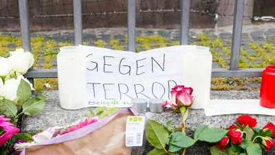 Kerzen, Blumen und ein Blatt Papier mit der Aufschrift „Gegen Terror“ stehen am Tatort auf dem Mannheimer Marktplatz. (Foto: Uwe Anspach/dpa)