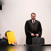 Vor Prozessbeginn verbarg der 55-jährige Angeklagte sein Gesicht hinter einem Aktendeckel. Stehend sein Pflichtverteidiger Johann Bund.  (Foto: Udo Güldner)
