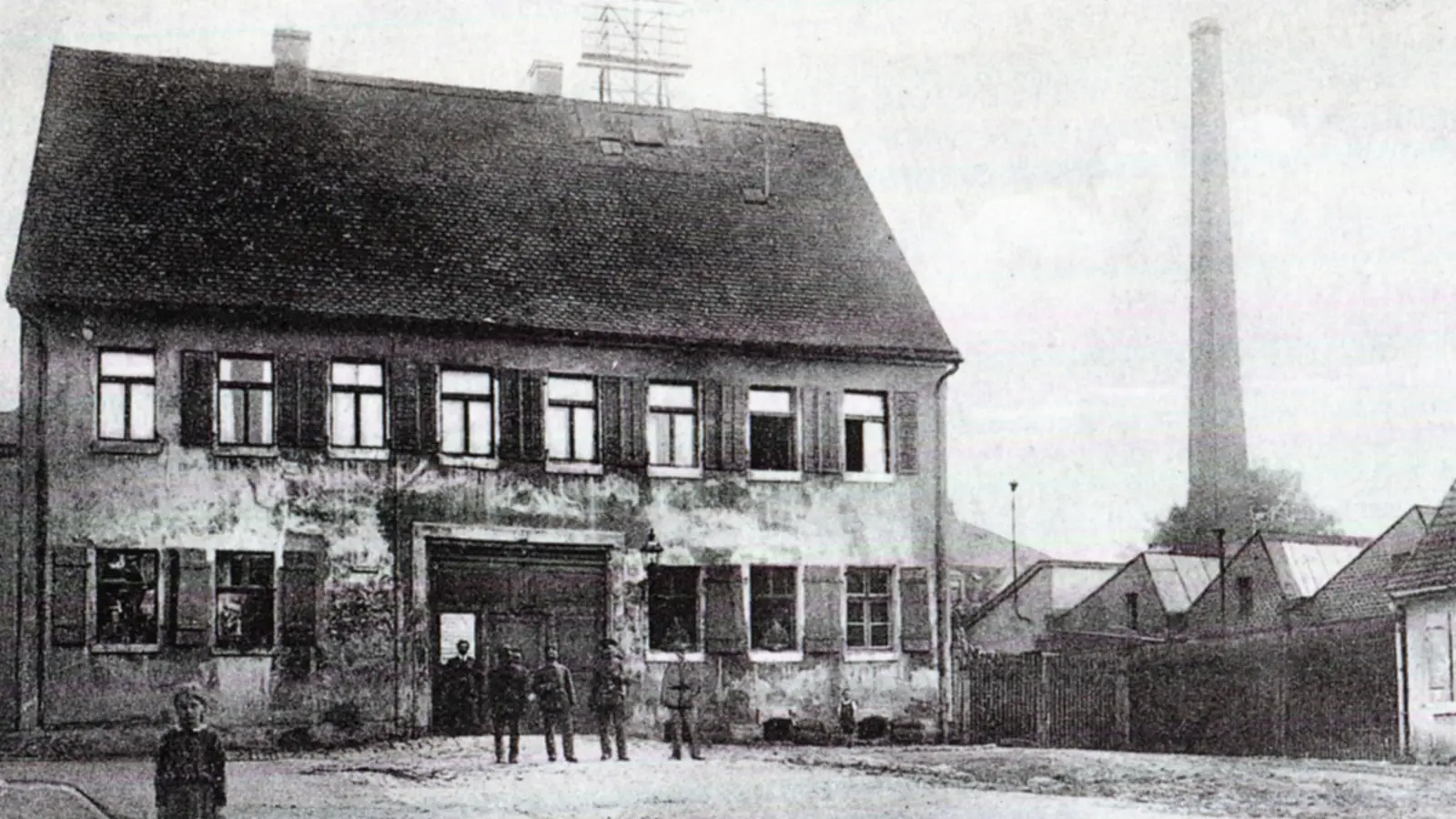 Das städtische Armenhaus, auch Versorgungshaus genannt, befand sich einst am südlichen Ende der Feuerbachstraße. Rechts in dieser historischen Aufnahme sind der Schornstein und die Fabrikhallen der Nähseidenfabrik Kupfer zu sehen. (Repro: Alexander Biernoth)