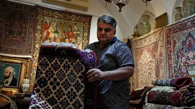 Ein iranischer Teppichhändler arbeitet in seinem Geschäft auf dem traditionellen Basar der Stadt Kashan. (Foto: Vahid Salemi/AP/dpa)
