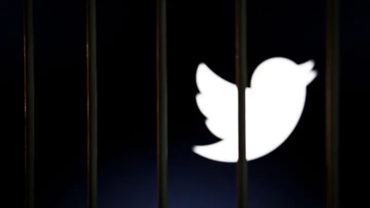 Das Twitter-Logo auf einem Bildschirm hinter Gittern. Ab dem 15. April wird sich für nicht zahlende Nutzer einiges ändern. (Foto: Andre M. Chang/ZUMA Press Wire/dpa)