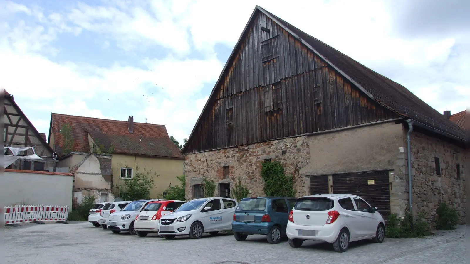 Die Roßmühle soll durch einen Neubau in Verlängerung des Bestandsgebäudes erweitert werden. Entstehen soll ein Zentrum für Physio- und Bewegungstherapie. Derzeit wird die Fläche noch von der Diakonie als Parkplatz genutzt. (Foto: Jasmin Kiendl)