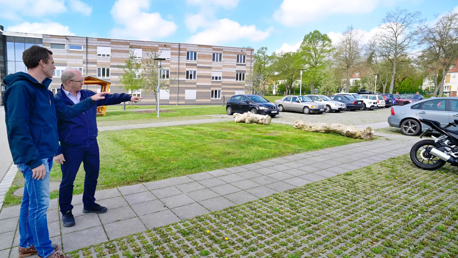 Der derzeitige Leiter der Abteilung Pflanzenbau und Versuchswesen Markus Heinz (links) wird am 1. Juli Nachfolger von Direktor Otto Körner (rechts). Beide schauen auf den Ort, wo das neue Gästehaus gebaut werden soll: der Parkplatz zwischen Mensa und einem Neubau. (Foto: Jim Albright)