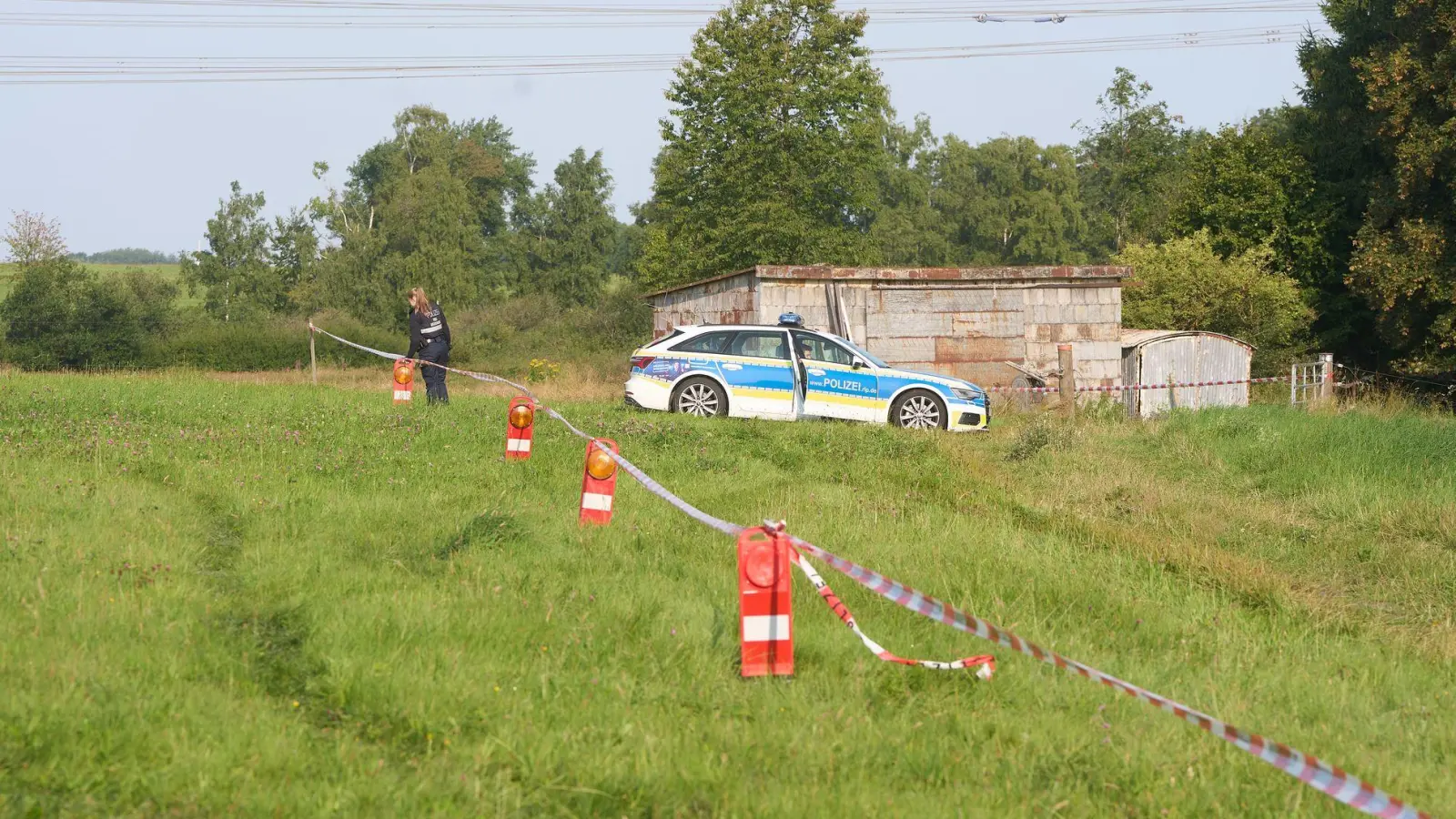 Die Polizei hat ein Gebiet nach dem Fund einer Leiche abgesperrt.  (Foto: Thomas Frey/dpa)