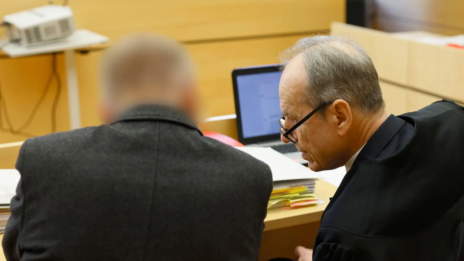 Der Angeklagte (l) und Rechtsanwalt Hans-Jürgen Spilling sitzen bei der Eröffnung des Prozesses im Verhandlungssaal. (Foto: Heiko Becker/dpa)