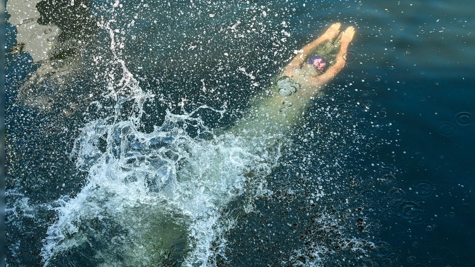 Nassforscher Protest: Ein Teilnehmer einer Schwimmdemo gegen das Badeverbot in der Spree in Berlin springt ins Wasser der Spree. (Foto: Jens Kalaene/dpa)