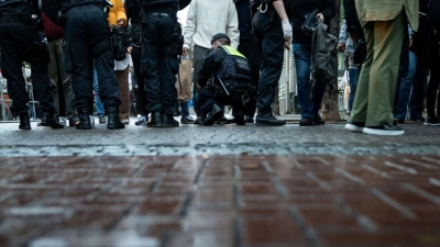 Polizisten kontrollieren Passanten in der Altstadt von Düsseldorf. (Foto: Fabian Strauch/dpa)