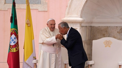 Bei der Willkommenszeremonie küsst der portugiesische Präsident Marcelo Rebelo de Sousa die Hand von Papst Franziskus. (Foto: Armando Franca/AP/dpa)