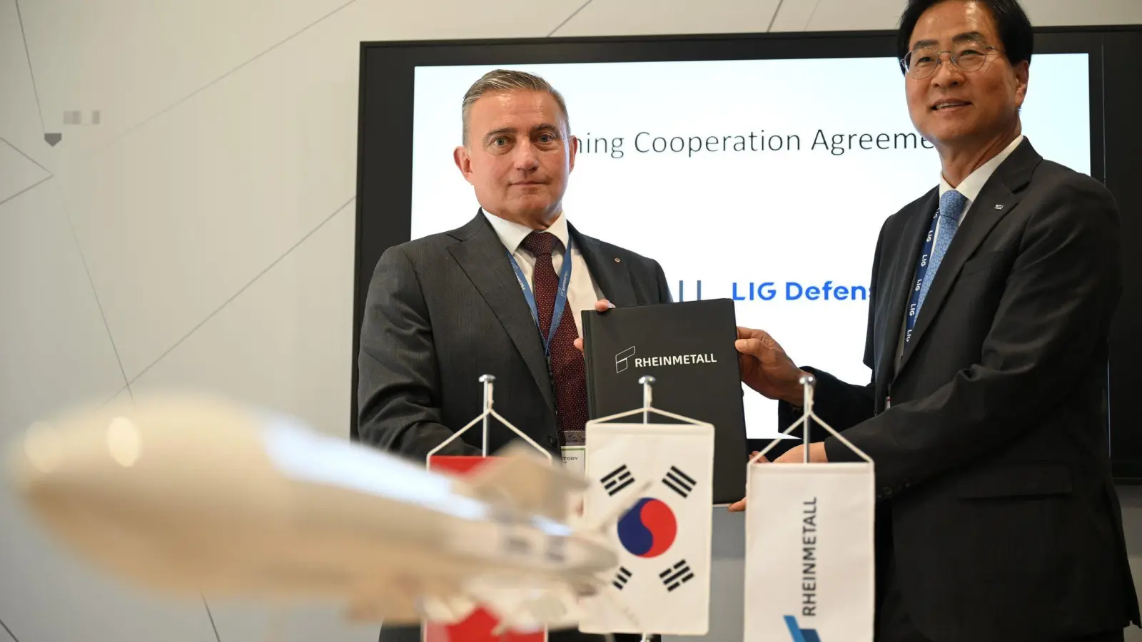 Rheinmetall-Manager Oliver Dürr und der südkoreanische Manager Ickhyun Shin nach der Unterschrift der Vereinbarung bei der Eurosatory. (Foto: Wolf von Dewitz/dpa)