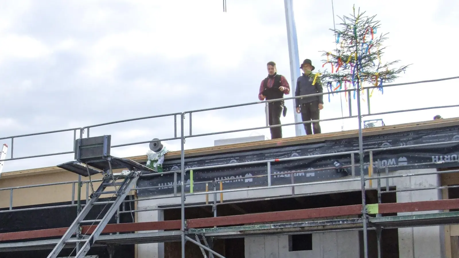 Sprach den Richtspruch: Philip Herzig (links) von der ausführenden Zimmerei. Manfred Dreiber assistierte ihm. (Foto: Jasmin Kiendl)
