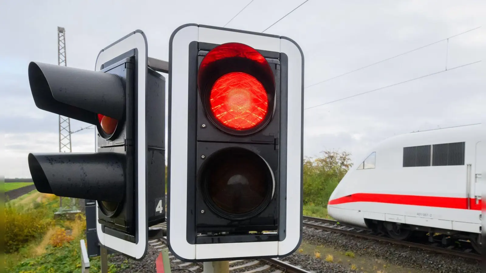 Eine rote Ampel leuchtet an einem Bahnübergang. Der Bahnverkehr auf der ICE-Strecke zwischen Köln und Frankfurt ist für eine Woche eingestellt. (Foto: Julian Stratenschulte/dpa)