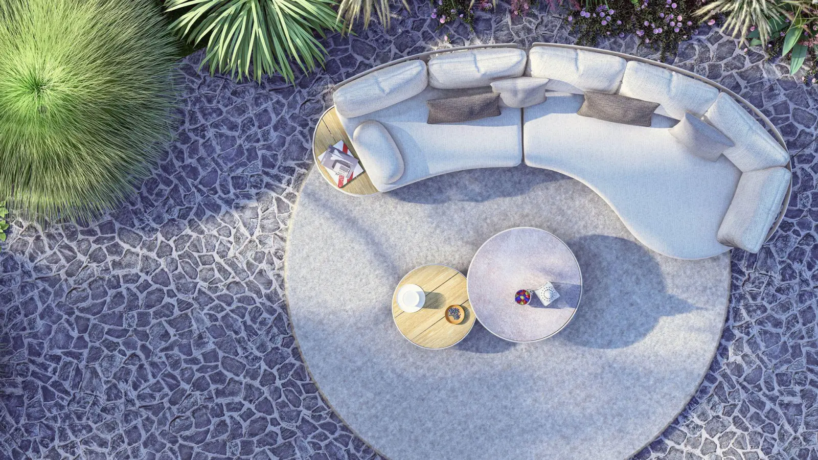 Wie aus einem Guss: Das Outdoorsofa von Zebra fügt sich mit dem Teppich und den beiden Tischen elegant als Einheit zusammen. (Foto: Zebra Group/dpa-tmn)