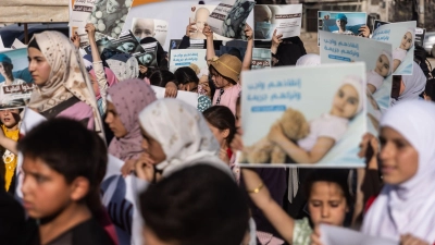 Menschen, die sich mit Krebspatienten solidarisieren, demonstrieren an der syrischen Grenze zur Türkei. (Foto: Anas Alkharboutli/dpa)