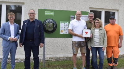 Landrat Marco Meier, Bürgermeister Michael Dörr, Sebastian Klostermeier, Thomas Hubinger, Michaela Botz vom Förderverein und Harald Zeller vom Bauhof (von links) freuten sich, dass ein weiterer Defibrillator-Standort am alten Kindergarten aufgestellt werden konnte. (Foto: Christina Özbek)