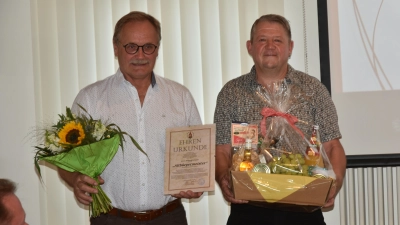 Die Blumen, die Urkunde und den Präsentkorb konnte der neue Altbürgermeister Wolfgang Schmidt (links) fürs Foto allein nicht tragen. Sein Nachfolger, Bürgermeister Johannes Hudezeck, half ihm gerne. (Foto: Anita Dlugoß)