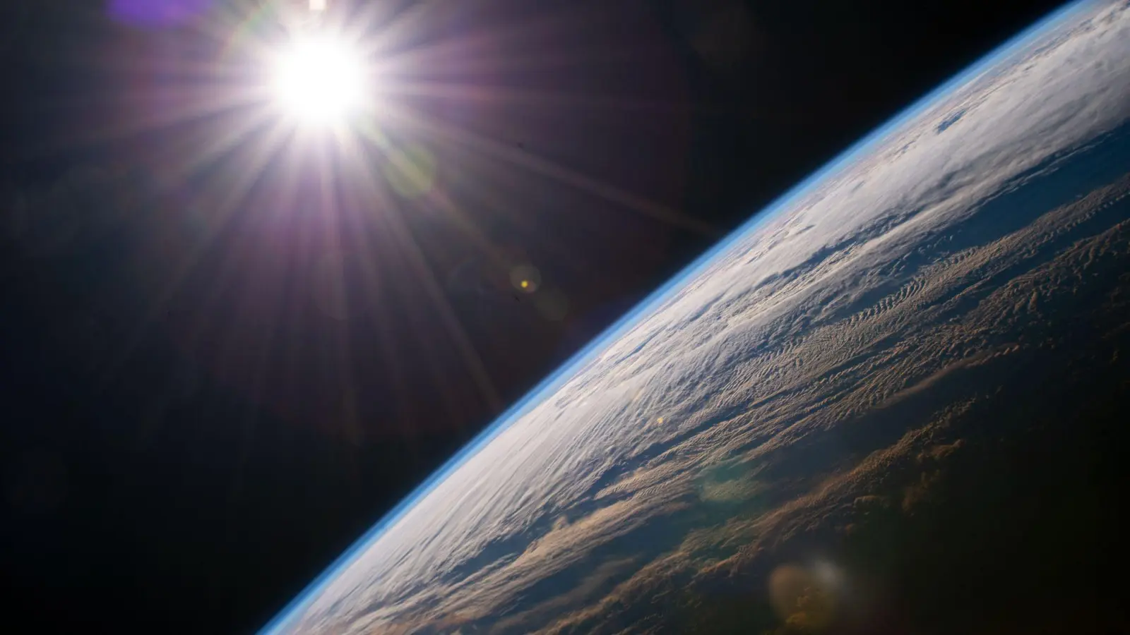 Die Sonne scheint über dem Horizont der Erde, während die Internationale Raumstation über der kanadischen Provinz Quebec kreist. (Foto: NASA/dpa)