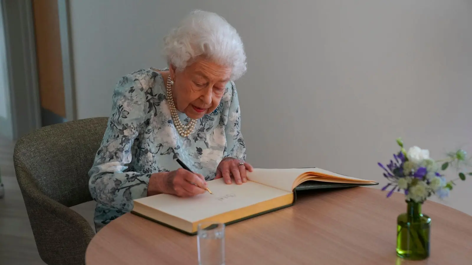 Königin Elizabeth II. trägt sich im Thames Hospizins Besucherbuch ein. (Foto: Kirsty O'connor/Pool PA/AP/dpa)
