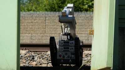 Ein Roboter ist auf dem Bahnhofsgelände im Einsatz. (Foto: Felix Kirberg/dpa)