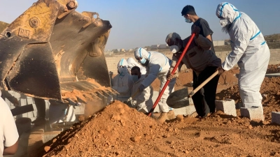 Helfer begraben Opfer der Sturzflut in Libyen. (Foto: Yousef Murad/AP/dpa)