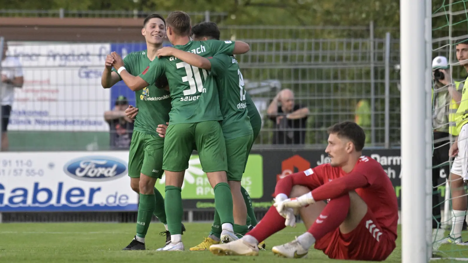 Schon sein zweiter Regionalliga-Treffer nach langer Verletzungspause: Michael Sperr (links) freut sich mit Jonas Sauerstein (Nummer 30) und Tanyel Deliboyraz über das 2:0. Wacker-Keeper Markus Schöller schiebt Frust. (Foto: Martin Rügner)
