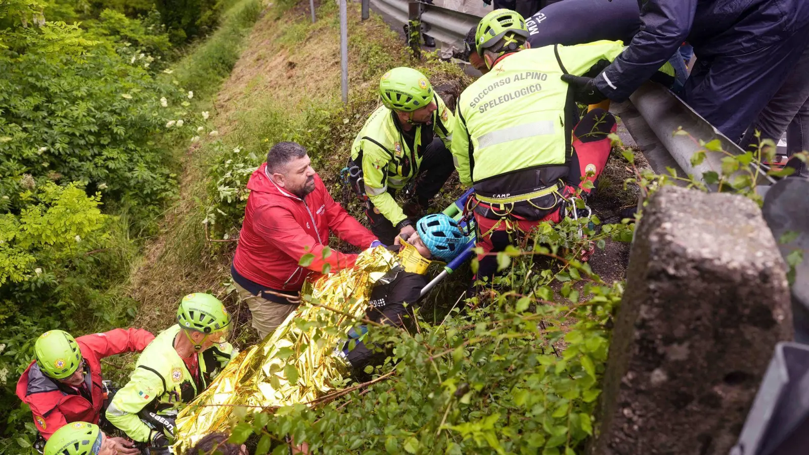 Der Italiener Alessio Martinelli wird nach seinem Sturz von Rettungskräften behandelt. (Foto: Fabio Ferrari/LaPresse/AP/dpa)