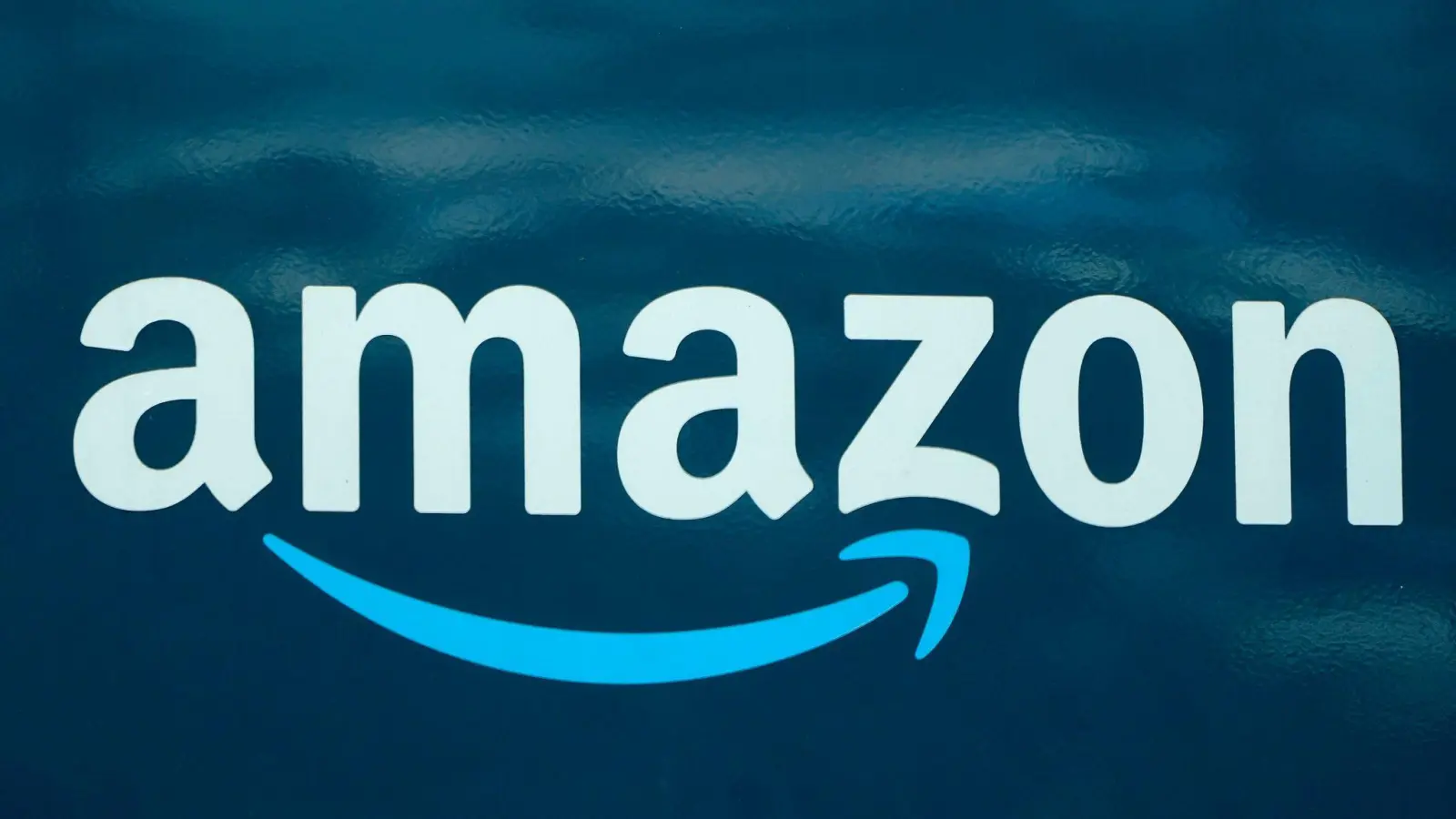 Ein Amazon-Logo auf einem Lieferwagen. (Foto: Steven Senne/AP/dpa)