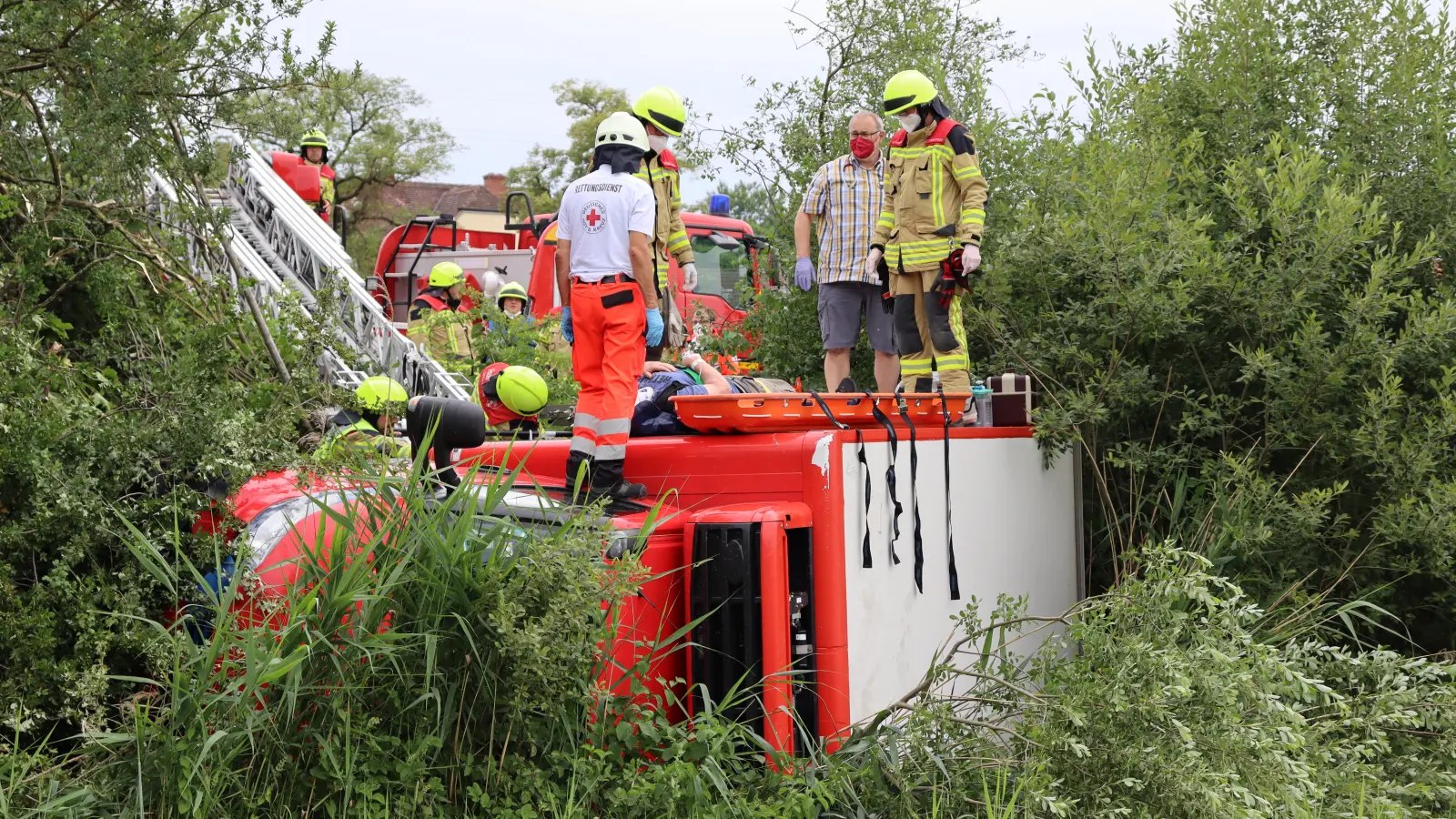 Helfer kümmern sich um den verletzten Lkw-Fahrer. Später wurde das Unfallopfer mit der Drehleiter geborgen. (Foto: Antonia Müller)