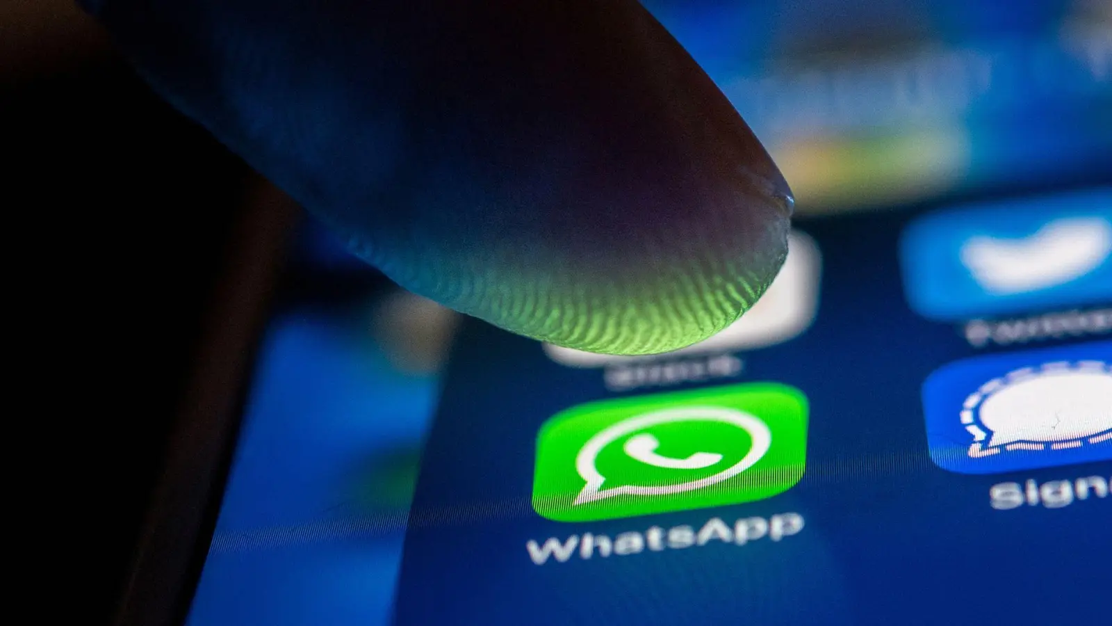 Ein Finger berührt das WhatsApp-Logo auf einem Smartphone. (Foto: Zacharie Scheurer/dpa)