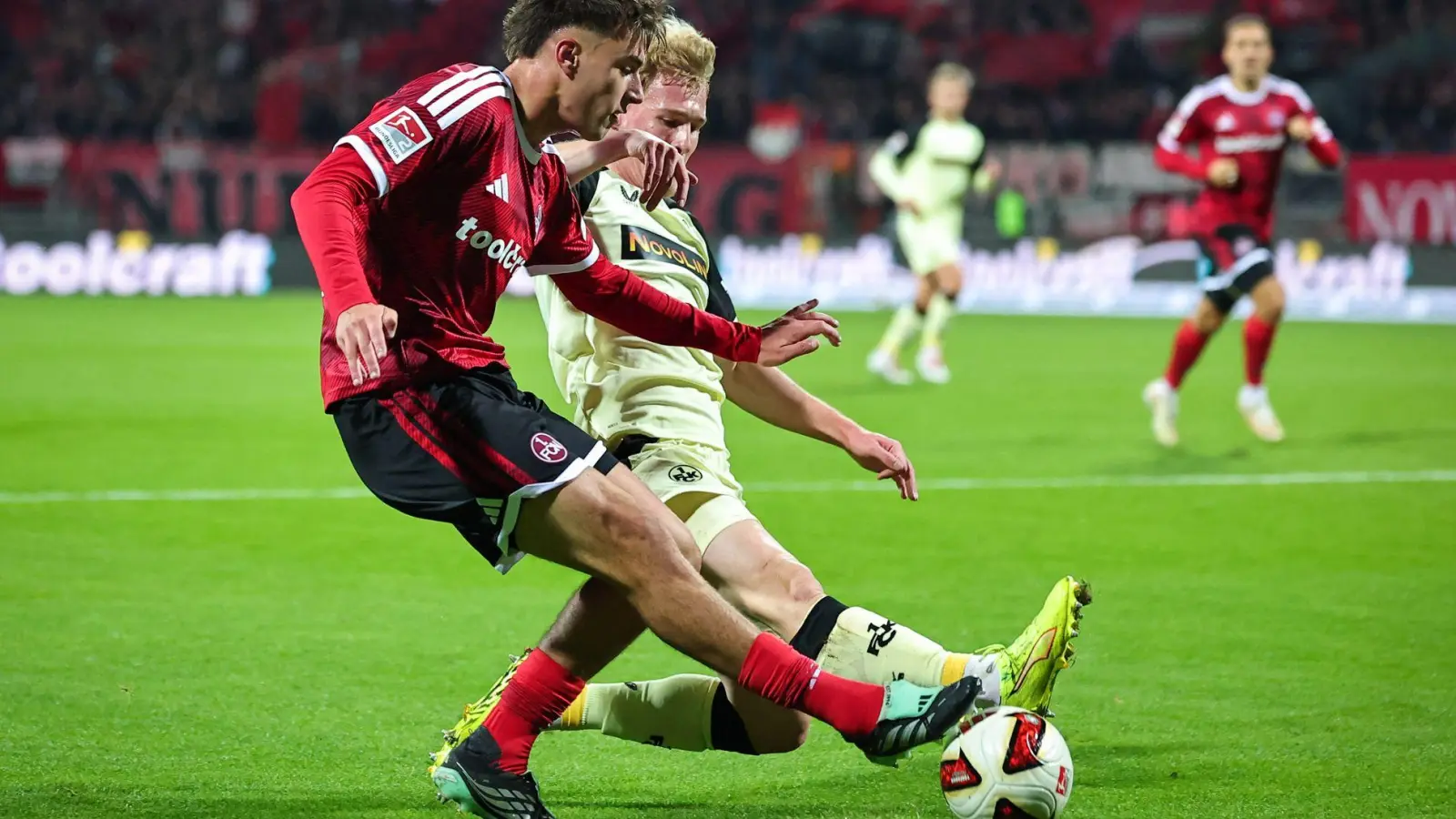 Nürnbergs Fernandez (vorne) im Zweikampf mit Kaiserslautern-Profi Haas. (Foto: Daniel Karmann/dpa)