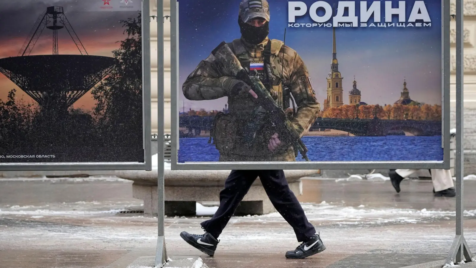 Ein Plakat mit dem Bild eines russischen Soldaten und der Aufschrift „Wir verteidigen das Vaterland“ in St. Petersburg. (Foto: Dmitri Lovetsky/AP/dpa)