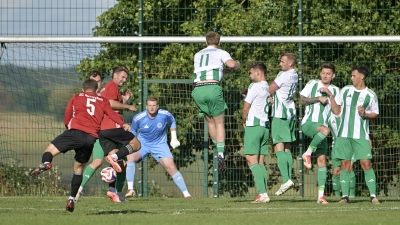 Daniel Holzmann (in rot mit der Nummer 5) bei einem Freistoß für den SC Aufkirchen, im Hintergrund FVU-Torwart Philipp Müller. (Foto: Martin Rügner)