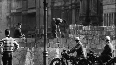 Arbeiter erhöhen die Sektorensperre an der Bernauer Straße in Berlin. Mit dem Bau am 13. August wurde vor 62 Jahren begonnen. (Foto: dpa)