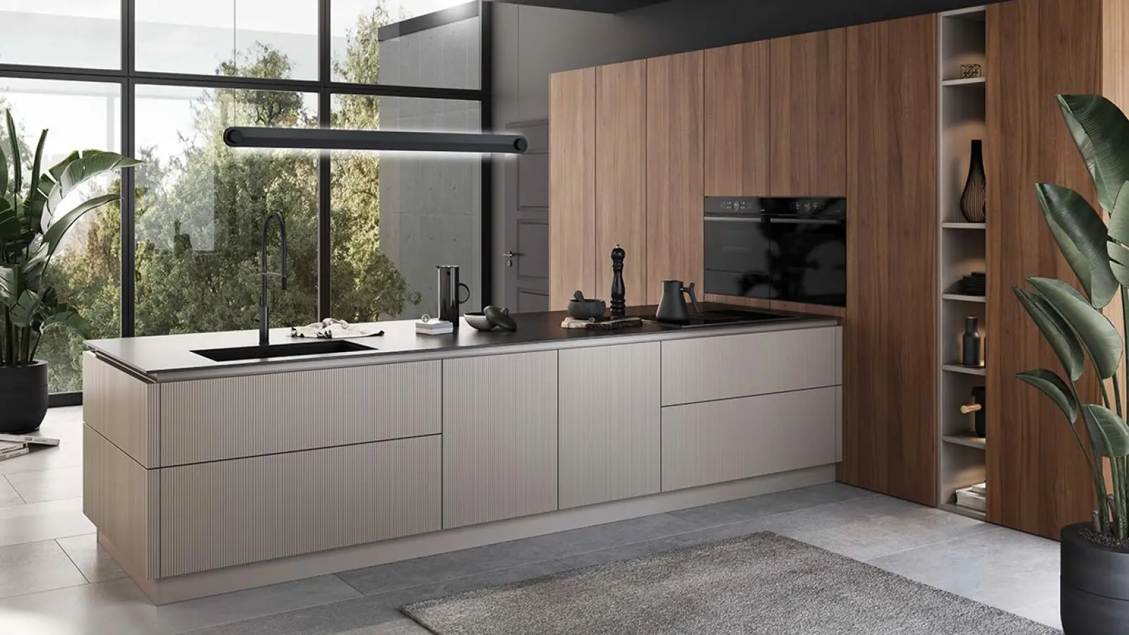 Glatte Holzfurnierfronten in Nussbaum mit vertikal verlaufender Maserung und Greige-farbene Oberflächen mit Rillenoptik bei der Insel machen den Reiz dieser Grifflos-Planung aus. Ein Premium-Schutzlack macht das Furnierholz unempfindlicher gegen Feuchtigkeit, Schmutz und Kratzer. (Foto: AMK)