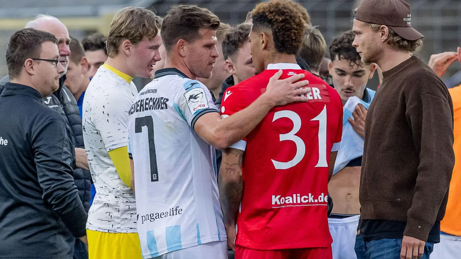 Florian Niederlechner (TSV 1860 München) spricht nach dem Rassismus-Vorfall aufmunternd mit Justin Butler (FC Energie Cottbus). (Foto: Heike Feiner/Eibner Pressefoto/dpa)