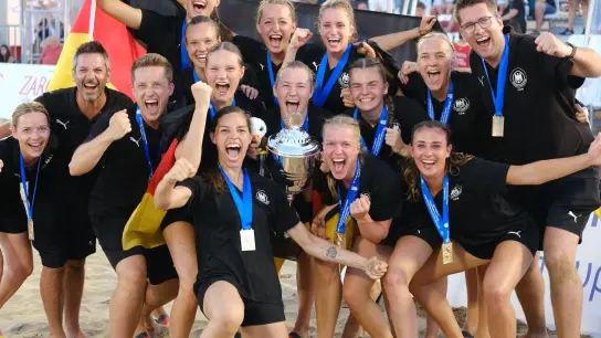 Deutschlands Beach-Handballerinnen um Kapitänin Lucie-Marie Kretzschmar (vorne 4.v.l) jubeln nach dem historischen WM-Triumph. (Foto: Julia Nikoleit/dpa)