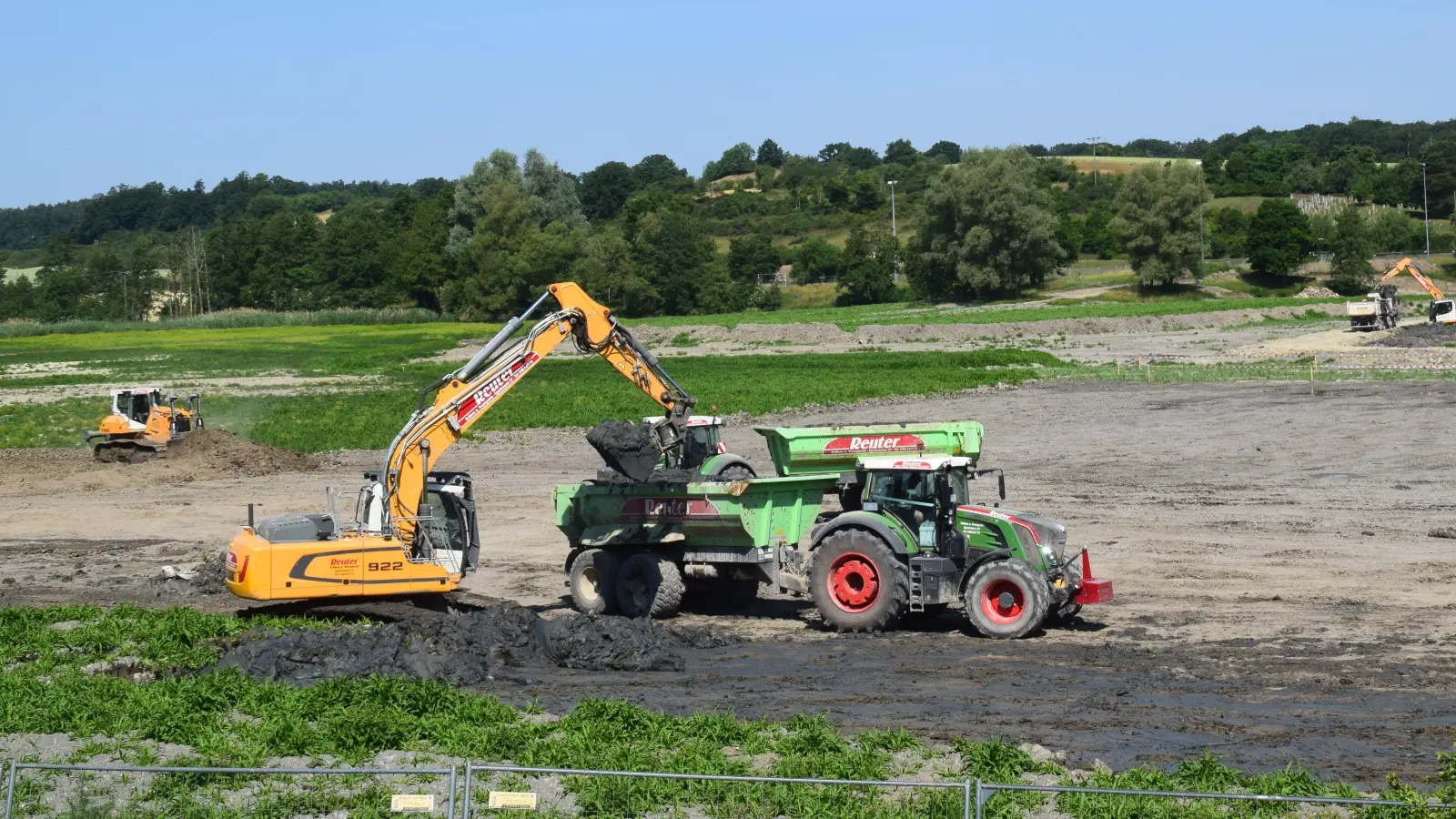 Bagger befördern die in Erdbecken getrockneten Sedimente in Muldenkipper. Links schiebt eine Raupe noch im flacheren Bereich des Sees Ablagerungen ab. (Foto: Gerhard Krämer)