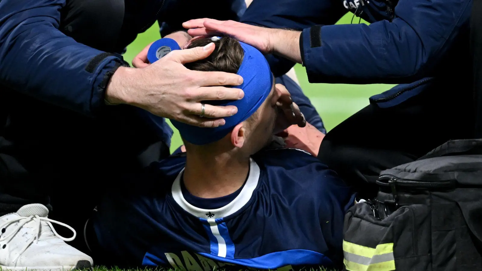 Kopfverletzung: Darmstadts Jannik Müller muss auf dem Platz behandelt werden. (Foto: Arne Dedert/dpa)